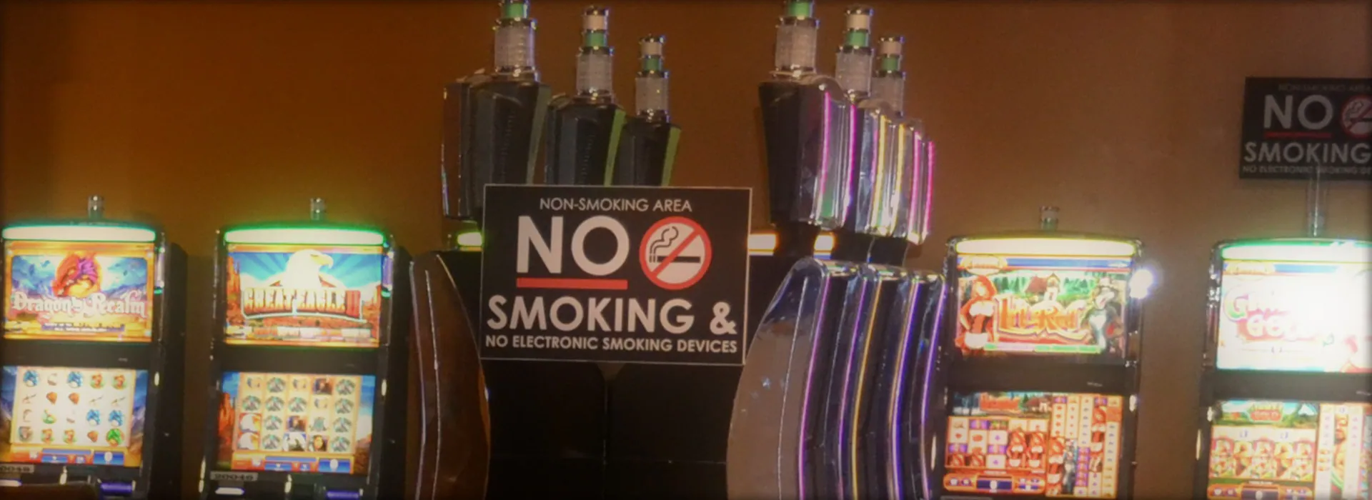 Slot machines around a no-smoking sign in WinnaVegas's smoke-free gaming area.